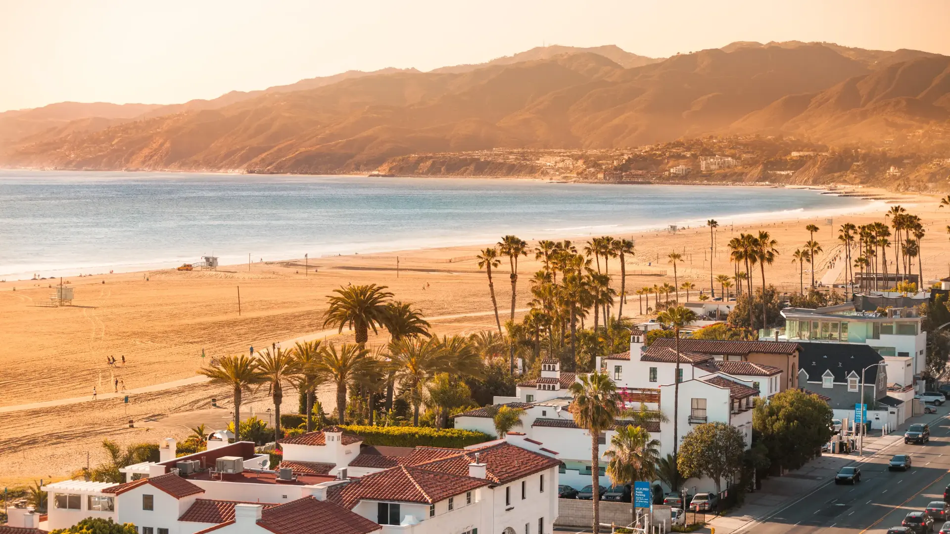 Aerial view of Santa Monica beach, shoreline residences and Santa Monica Mountains at golden hour